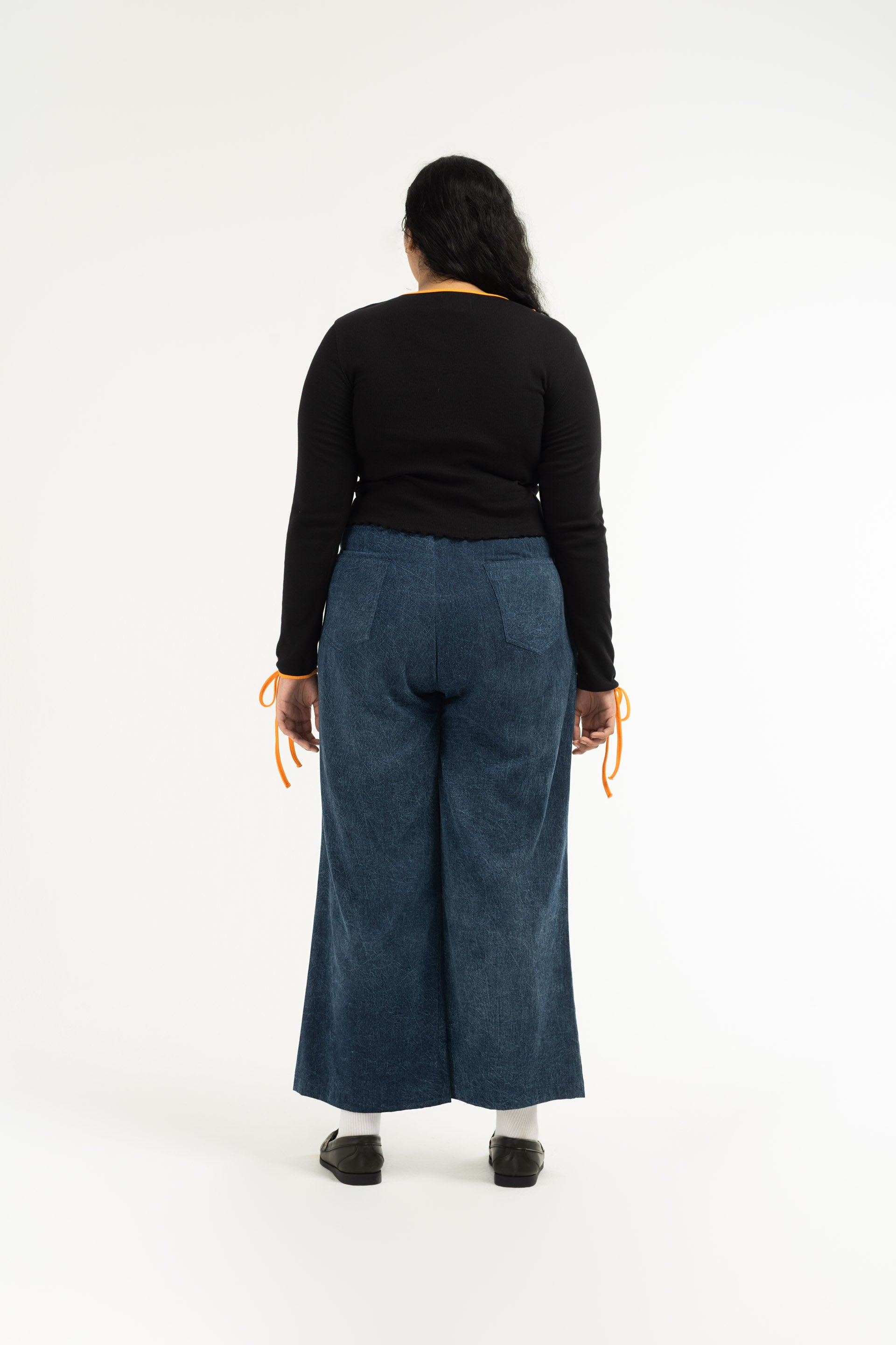 Stonewash Wide Leg Pants are unisex designed and are mid-rise with a wide flare leg that falls just above the ankle. 